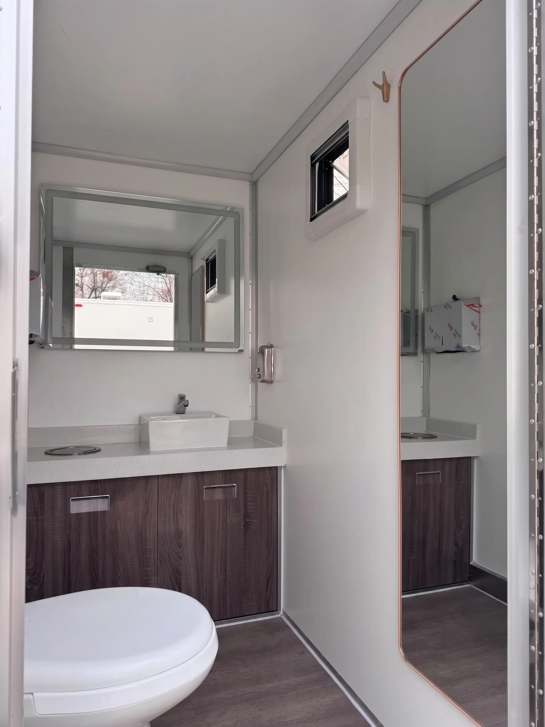 Interior of a Luxury Loos restroom trailer with vanity and mirror
